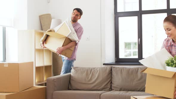 Happy Couple with Stuff Moving To New Home