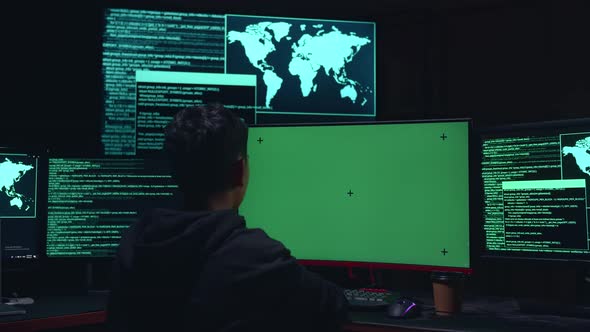 Child Hacker Hacking With Isolated Mock-Up Green Screen And Code On Multiple Computer Screens