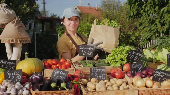 Farmer Seller Holding Eco Paper Bag with Fresh Vegetables