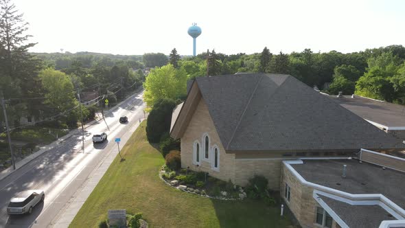 Aerial panorama over church building in Excelsior, Minnesota, on a right day. Water tower seen.