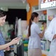 caucasian male pharmacist explaining the medicinal properties on the pillbox to a patient - VideoHive Item for Sale