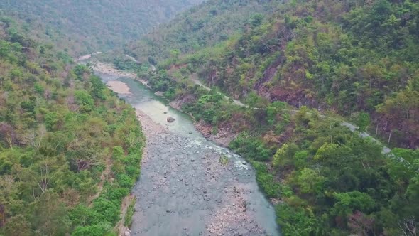 Flycam View Rocky River Near Road Between Tropical Plants