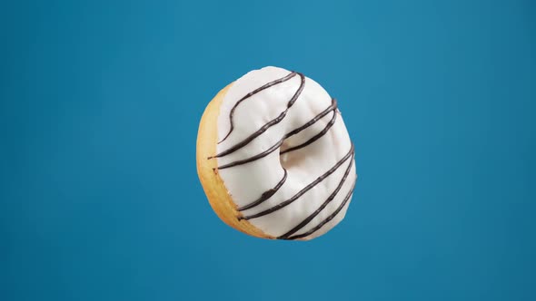 Isolated Glazed Donut Rotating at Blue Background