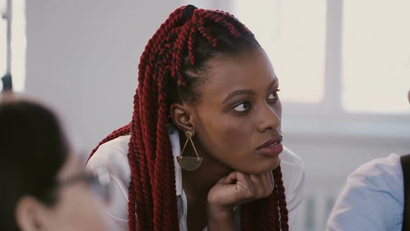 Portrait of Young Positive Black Professional Business Woman Listening, Smiling at Team Discussion