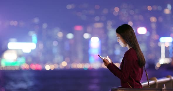 Woman use smart phone online at night