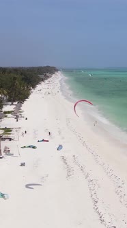 Vertical Video Kitesurfing Near the Shore of Zanzibar Tanzania