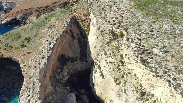 Drone shot over rocks in nature over rocks & the Mediterranean sea of Malta