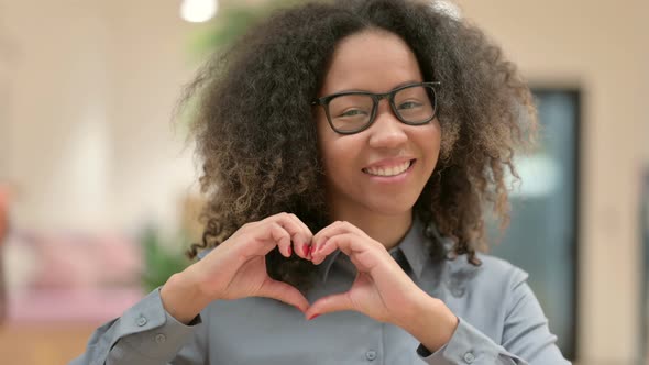 Portrait of African Businesswoman Showing Heart Sign