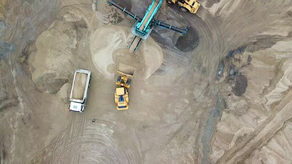 Sand mining industry. Bulldozer machine. Crawler bulldozering at sand mine. Mining machinery working