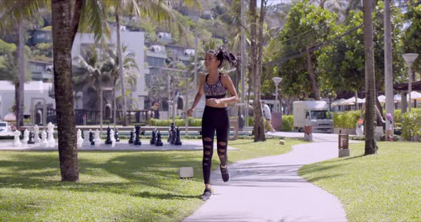 Asian Cheerful Woman Running in Park