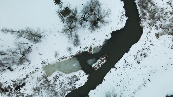 City park in winter. A meandering river is visible. Winter cityscape. Aerial photography.