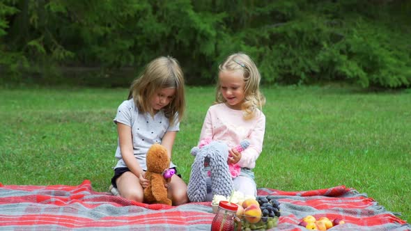 Little Girls Playing with Toys in the Park