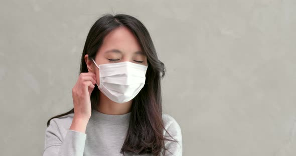 Woman Taking Off the Face Mask