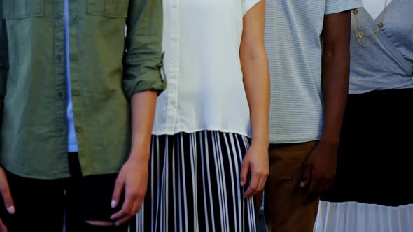 Portrait of smiling executives standing with arms crossed