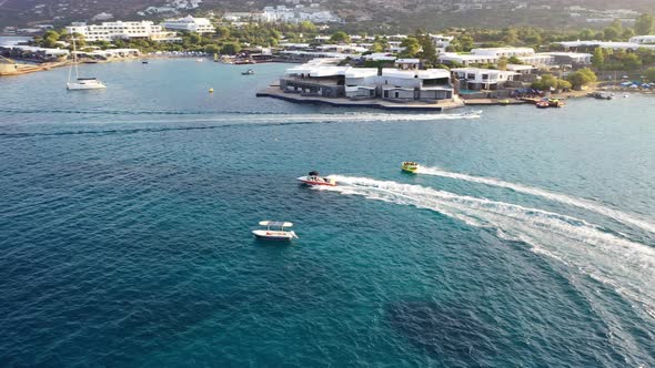 Aerial View of a Motor Boat Towing a Tube. Elounda, Crete, Greece