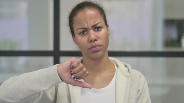 Portrait of African Woman Showing Thumbs Down Gesture