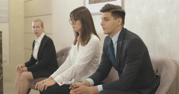 Nervous Men and Women Sitting in Office Hall Waiting. Portrait of Stressed Caucasian Employees in