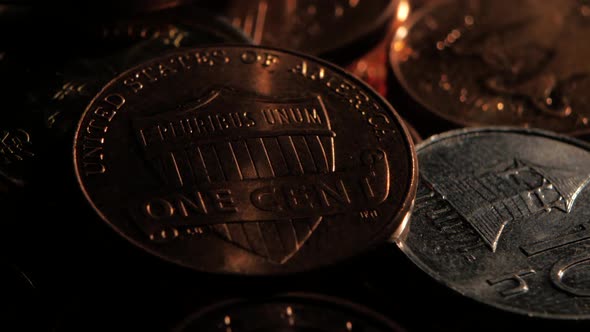 Copper Coin Lies Near Silver Coins in a Dark Room. Close Up