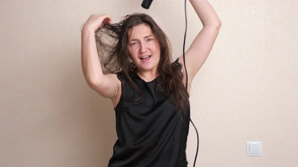 Lady Holds Hair Dryer in Hand and Dries Dancing and Singing