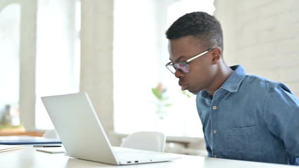 Young African Man Standing and Going Away in Office