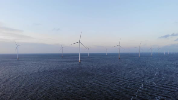 Offshore Windmill Park with Clouds and a Blue Sky Windmill Park in the Ocean Drone Aerial View with