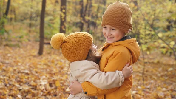 Happy Kids with Little Kids in Autumn Park on Sunny Day