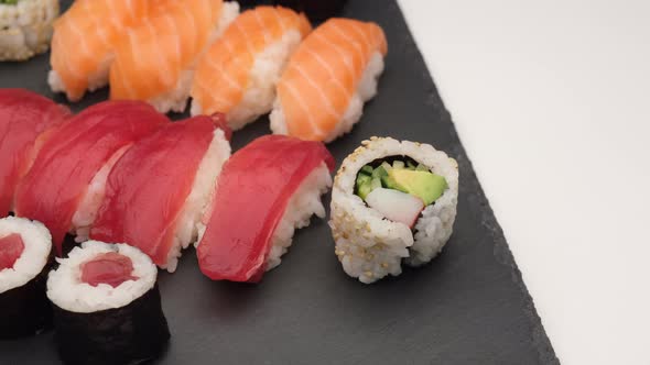 Sushi assortment nigiri salmon, tuna, uramaki, hosomaki on plate. Asian Japanese traditional food.