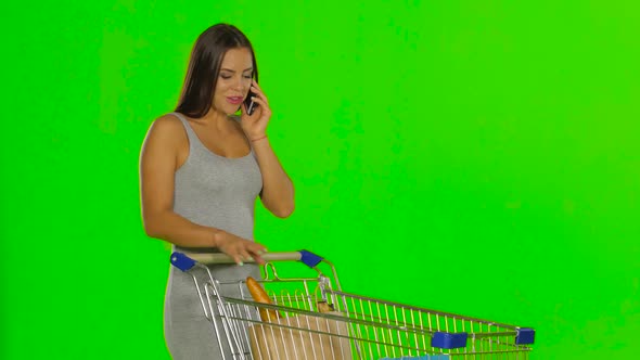 Woman Made the Purchase and Calls on Mobile. Green Screen