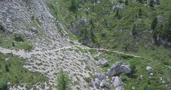 Aerial drone view of a group of people hiking in the mountains