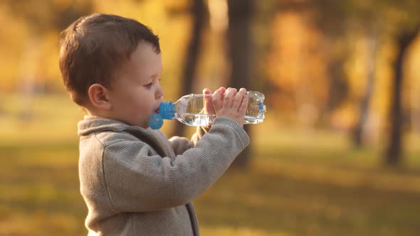 Little Boy Drinking Water on Nature