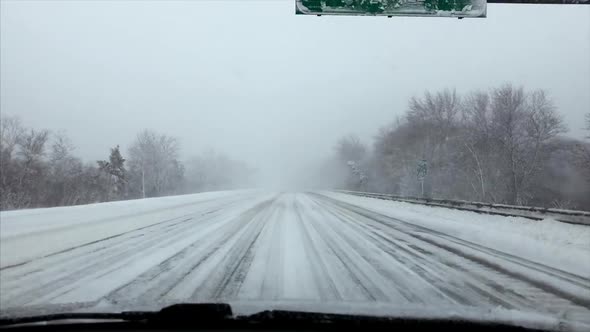 Driving on the highway during a blizzard alt