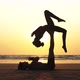 Fit Sporty Couple Practicing Acro Yoga with Partner Together on the Sandy Beach - VideoHive Item for Sale
