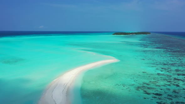 Tropical drone copy space shot of a white sandy paradise beach and aqua turquoise water background 