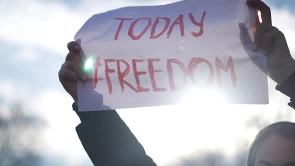 Freedom Today Placard in Sunrays Outdoors in Female Caucasian Hands