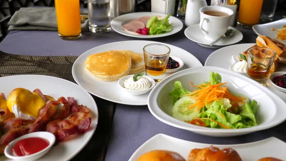 Table with Buffet Breakfast Food and Drinks in Hotel Resort Restaurant or Cafe