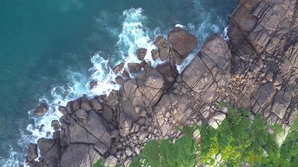 Tropical Ocean Shore with Large Stones and Flexible Woman