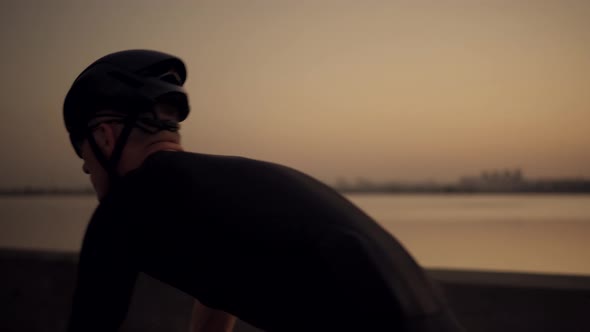 Cyclist Rider In Helmet And Sportswear Riding Workout At Sunset On Triathlon Time Trial Bicycle.