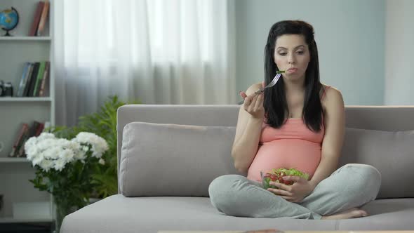 Pregnant Girl Observing Correct Diet, Eating Healthy Vegetable Salad, Vitamins