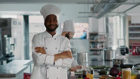 Portrait of Confident Man Working As Chef in Gourmet Kitchen