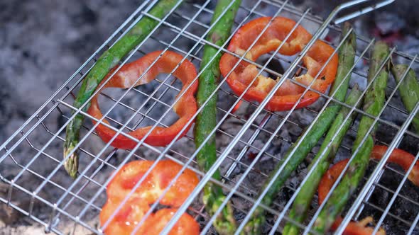 Making Grilled Vegetables  Asparagus and Red Pepper on a Charcoal Grill