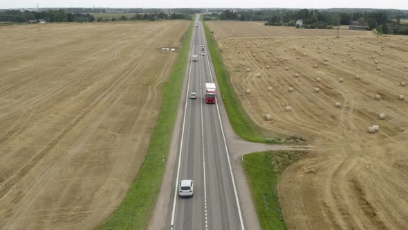 Left Hand Drive Trucks Driving Along a One Lane Motorway