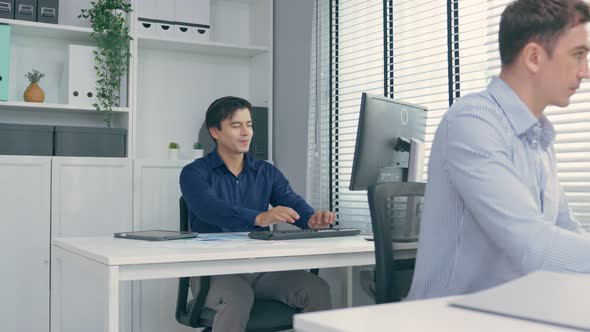 Attractive male employee worker greeting and making high five with colleagues in corporate workplace