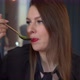 A Young Woman Eats Soup with a Spoon - VideoHive Item for Sale