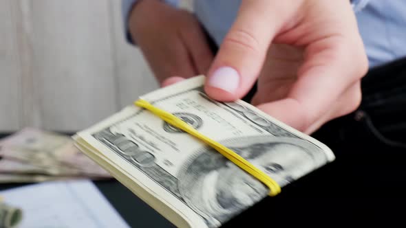 Business Woman Displaying a Spread of Cash US Dollars