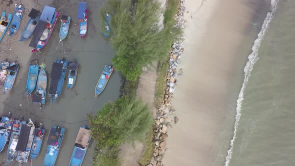 Aerial top down view fishing boat protected from wave