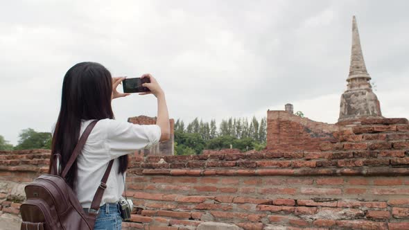 Japanese backpacker female enjoy her journey at amazing landmark in traditional city.