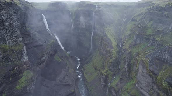 Tall mossy cliffs with waterfalls