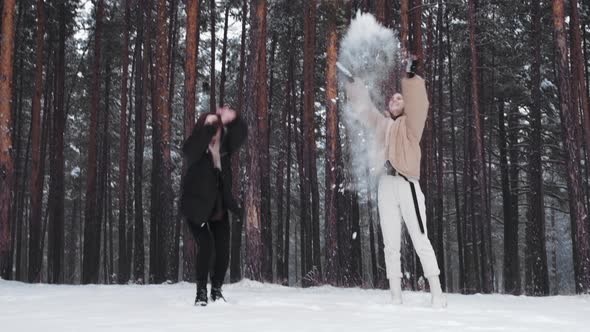 Happy Carefree Girls Throw Snow and Bounce in Slow Motion