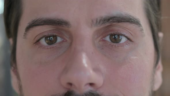 Close Up of Blinking Eyes of Young Man