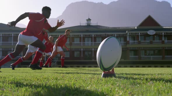 Rugby player kicking the ball from the kicking tee in the stadium 4k